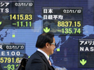 Japan's economy has been struggling for two decades and faces some of the same problems the U.S. has. Here, a man in Tokyo passes an electronic board displaying falling global markets. Japan's economy has been struggling for two decades and faces some of the same problems the U.S. has. Here, a man in Tokyo passes an electronic board displaying falling global markets.